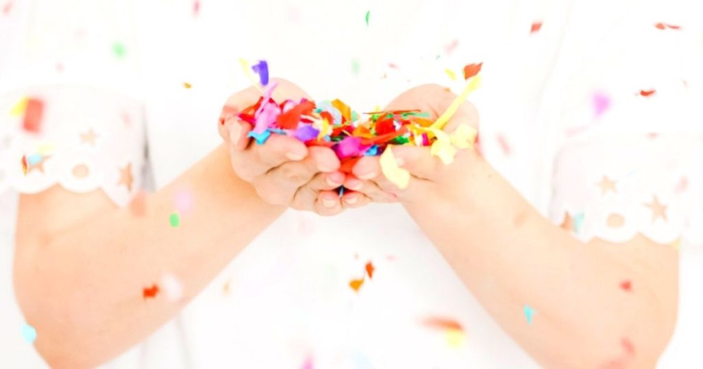Image of woman blowing confetti for how to write a cover letter