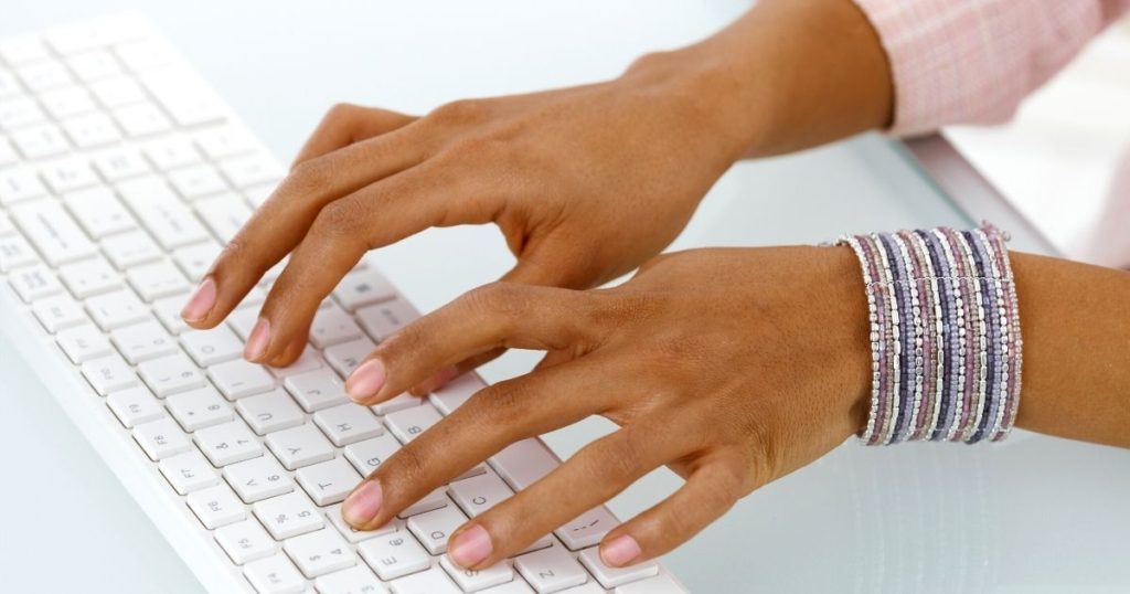 Woman's hands typing a cover letter address