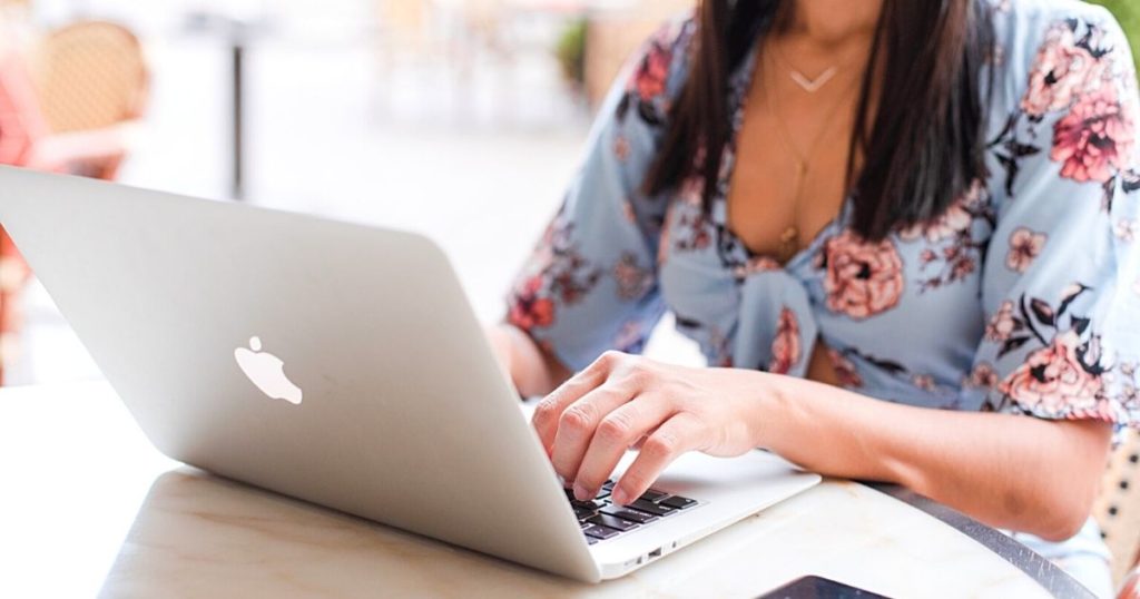 Woman typing on laptop for how to write a cover letter guide
