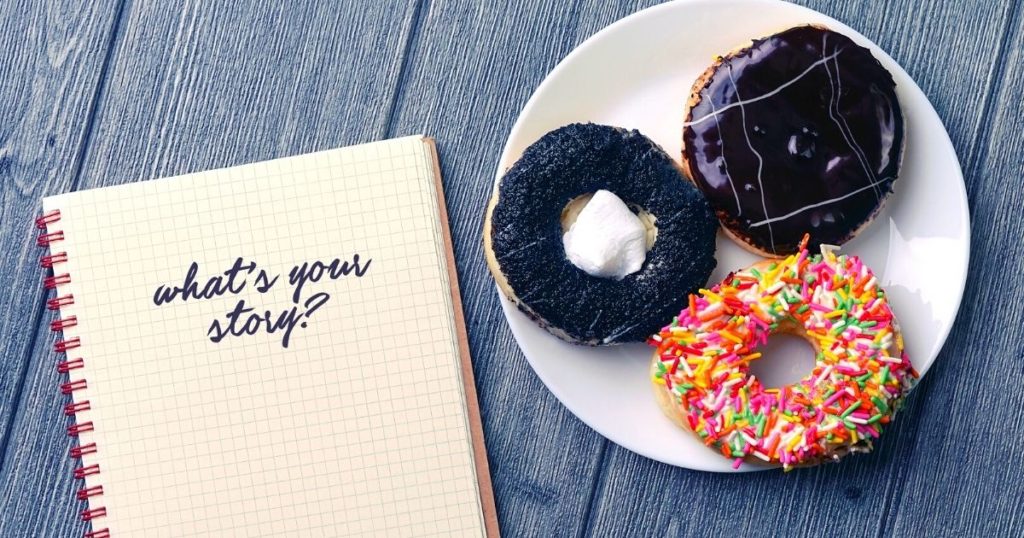 A journal that says "what's your story?" and a plate of donuts