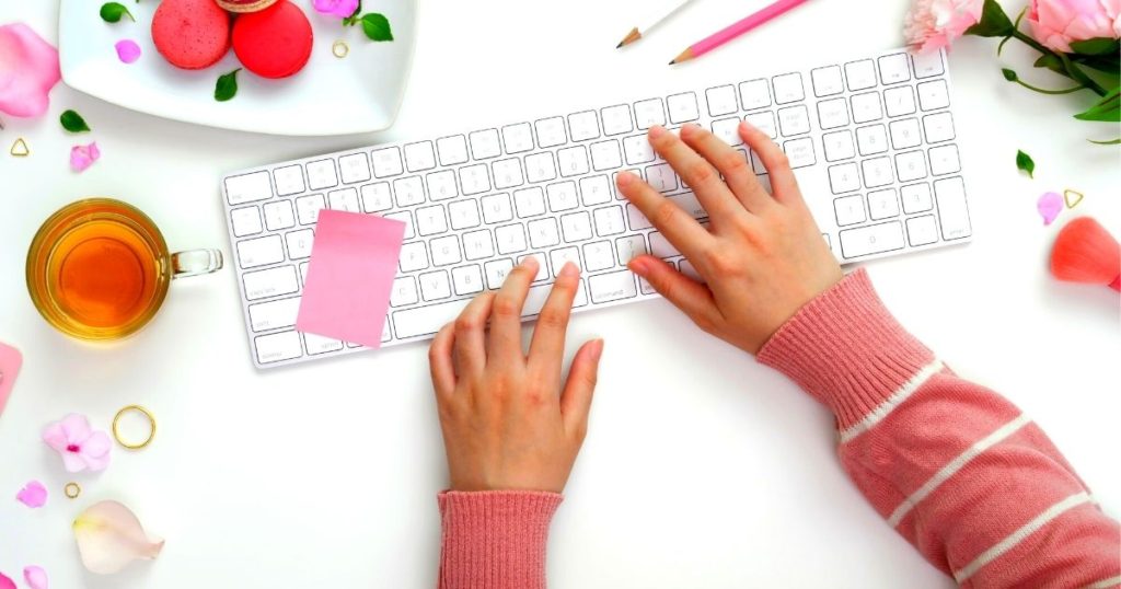 person typing on a colorful desk