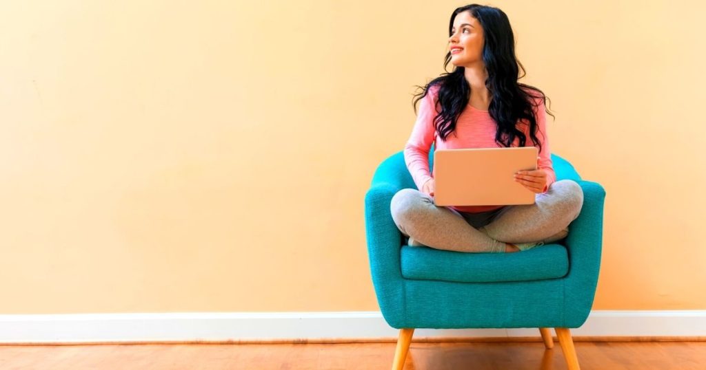 Woman with a laptop thinking about her master resume