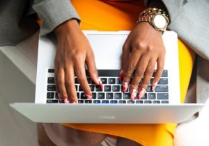 woman typing a resume on her laptop